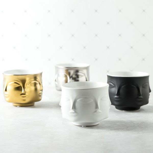 small ceramic vases with face